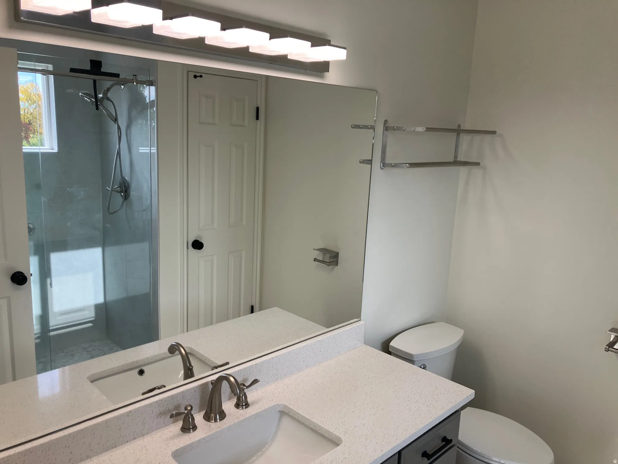 Bathroom featuring a double vanity with stone-finish countertops and undermount sinks