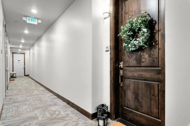 Rich wood-panel entry door featuring decorative hardware
