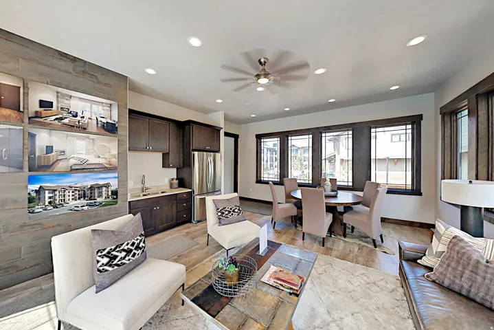 Open-concept living space with dark wood-finish cabinetry, stainless steel appliances, recessed lighting, and a ceiling fan