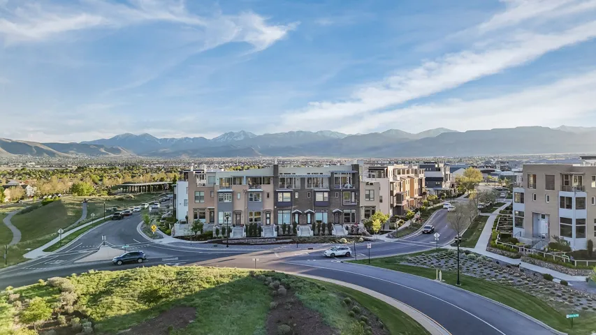 Modern architectural townhomes featuring multiple levels, balconies, and a community setting