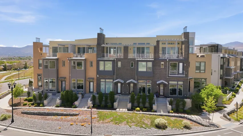 Modern townhome exteriors featuring varied facade materials including brick, stucco, and paneling