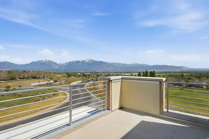 Outdoor balcony with a smooth concrete surface and modern metal railings