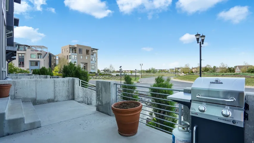 Concrete patio with integrated steps and a stainless steel railing system