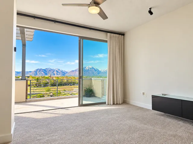 Expansive sliding glass doors open to an outdoor balcony