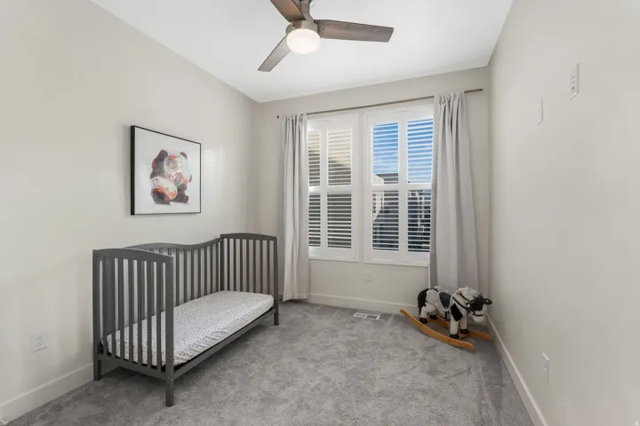 Soft gray carpeting with white baseboards throughout
