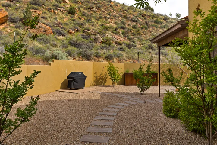 Desert landscaping with a gravel ground cover and flagstone pathway