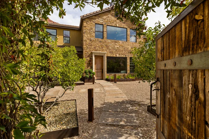 Stone facade residence featuring a decorative wooden entry door