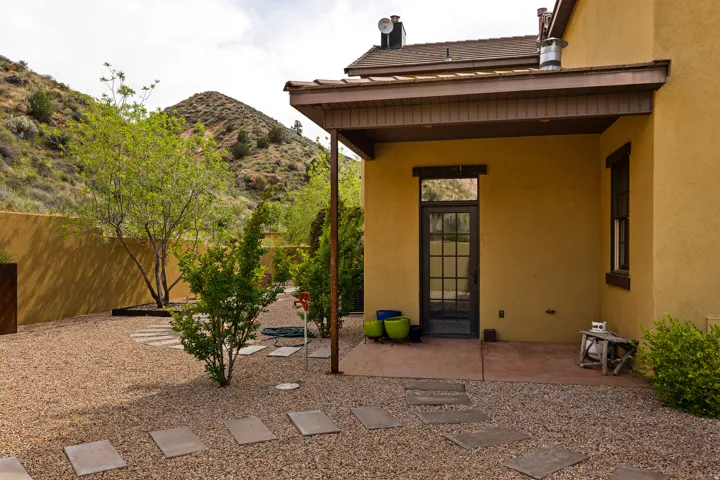 Rear exterior featuring a covered patio, stucco siding, and a glass-paneled door