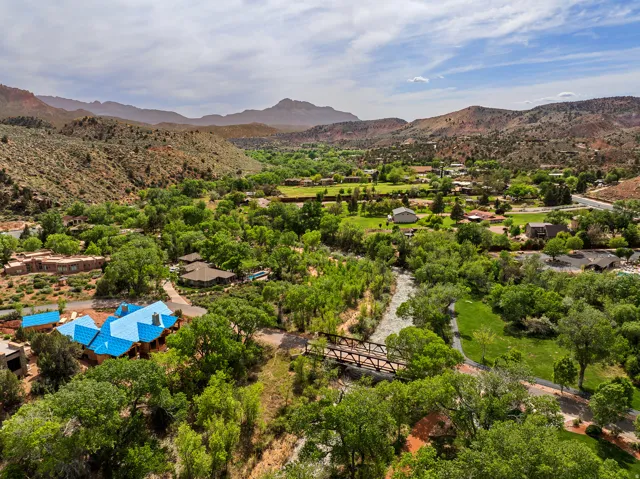 Expansive aerial view showcasing a natural landscape with mountainous terrain and abundant greenery