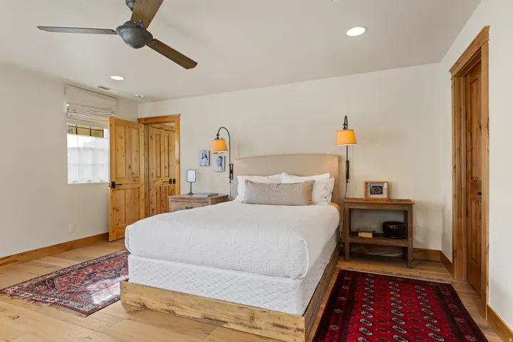 Interior room featuring wood-finish flooring, wood trim, and wood doors