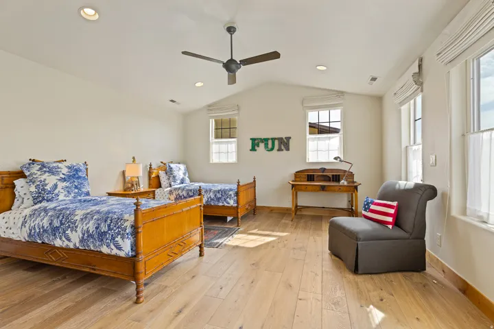 Vaulted ceilings with recessed lighting and a ceiling fan