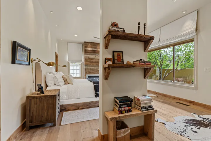 Room featuring wood-finish flooring, recessed lighting, and a window with outdoor greenery