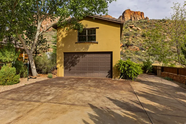 Stucco exterior with a two-car garage and a paved driveway
