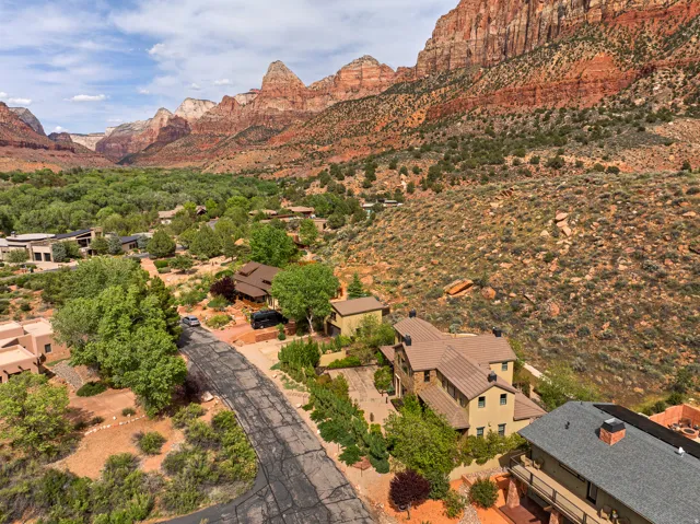 Expansive aerial showing multiple residential properties nestled within a natural landscape