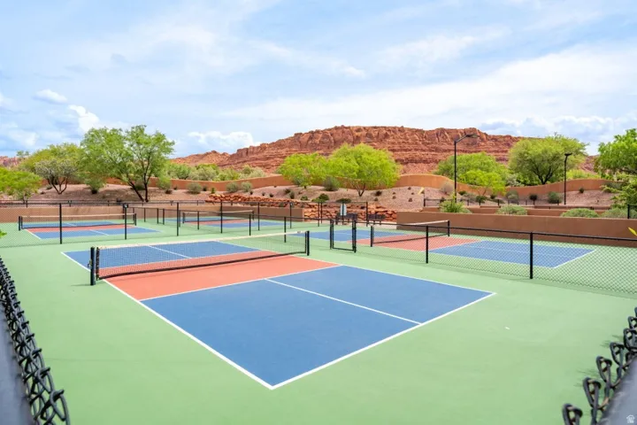 Multiple pickleball courts featuring blue, orange, and green surfacing