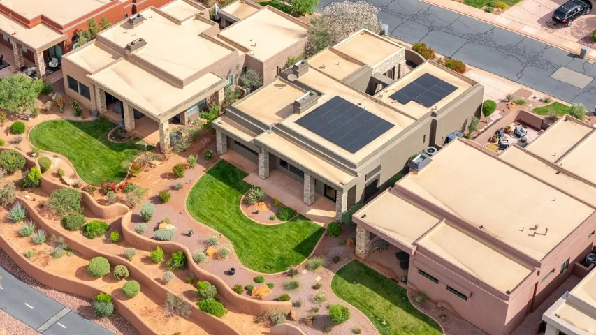 Expansive desert landscaping featuring terraced garden beds with varied drought-tolerant plantings