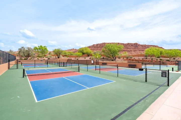 Multiple pickleball courts featuring blue, red, and green surfacing