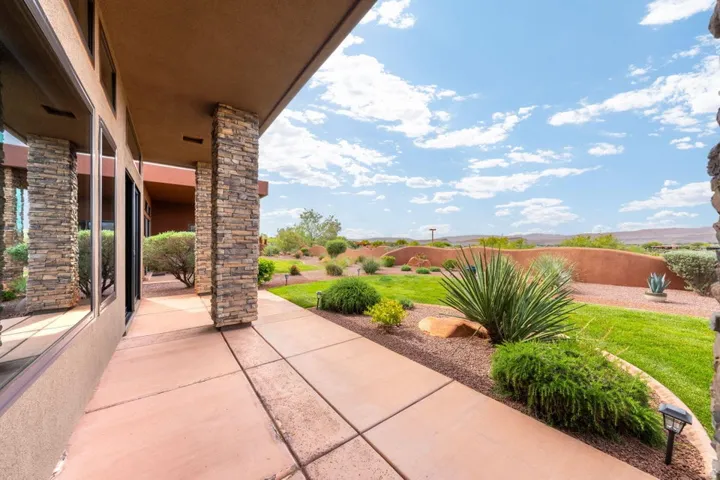 Patio with concrete slab flooring and stacked stone columns
