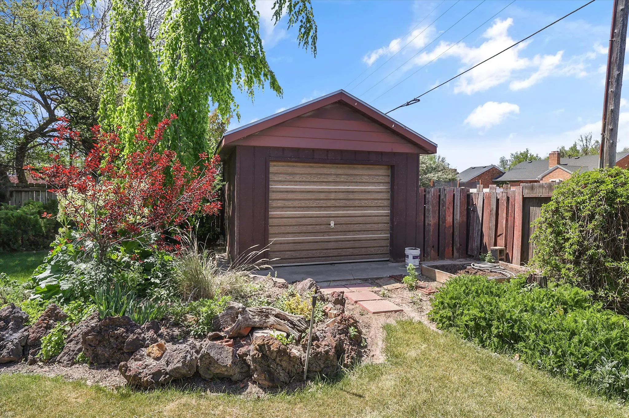 Detached garage with a roll-up door, set on a concrete pad