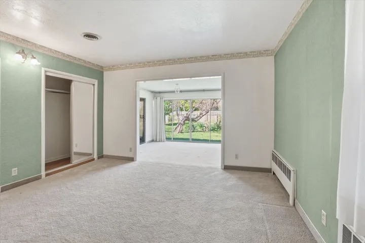 Carpeted interior space with mint green accent walls and white trim