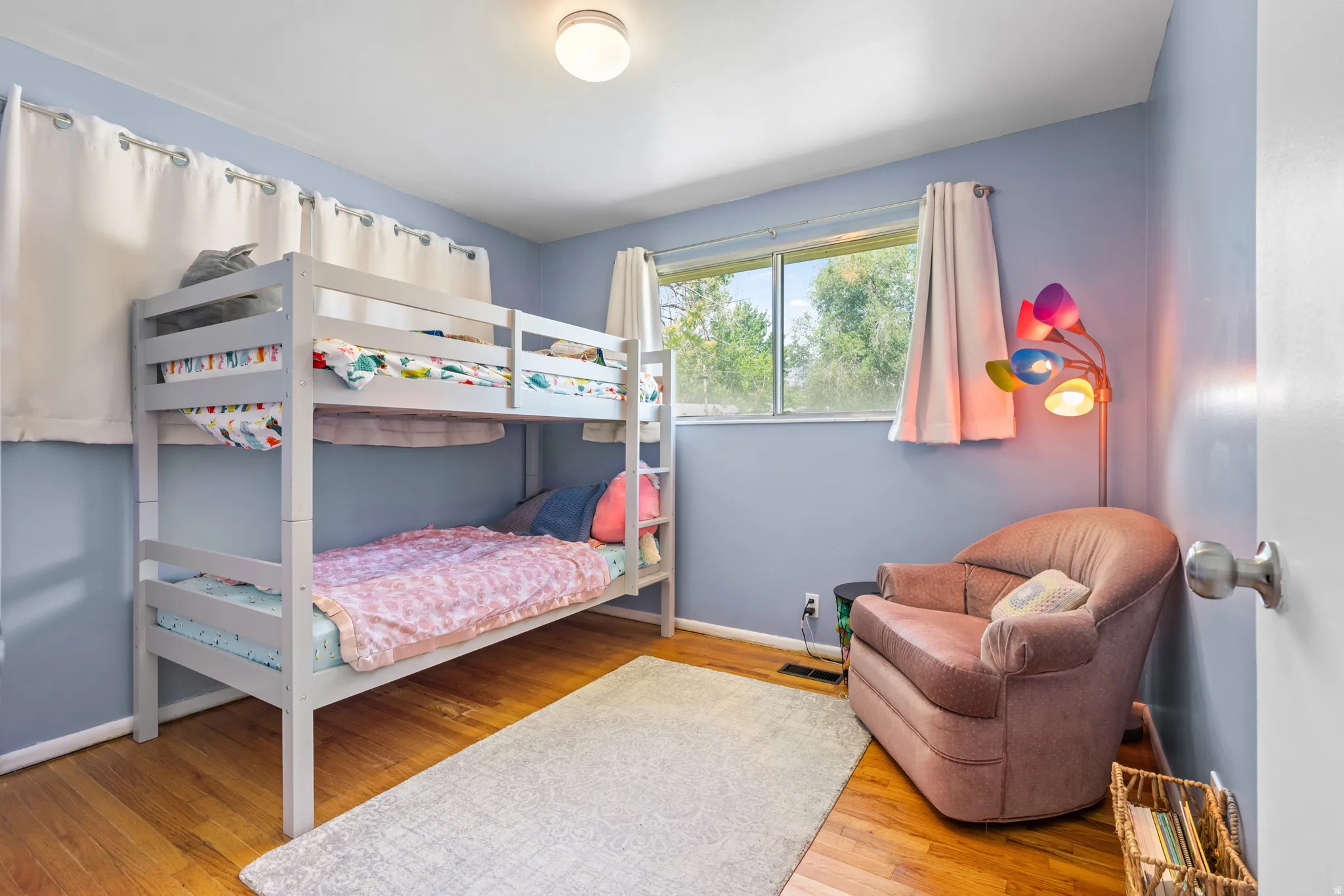 Hardwood flooring complements light blue walls in this room
