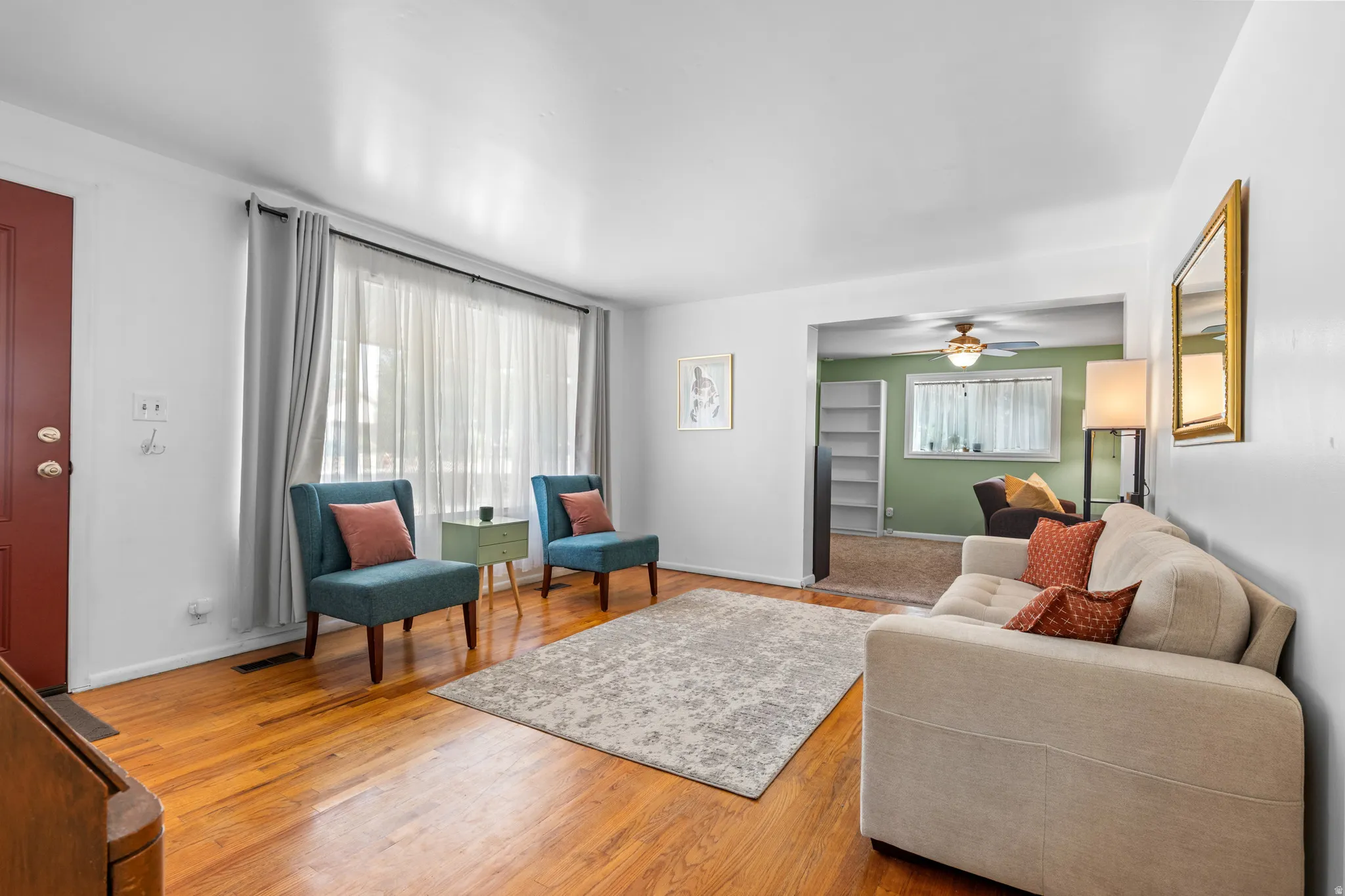 Bright living space featuring warm wood-finish flooring