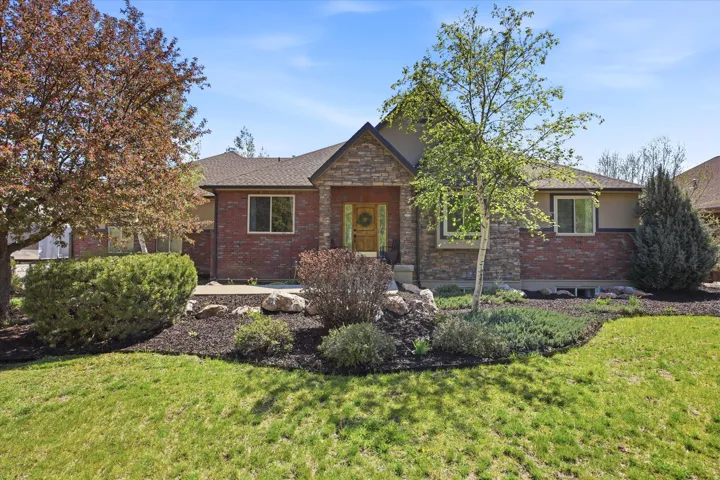 Exterior featuring a brick and stone facade, a gabled roofline, and multiple windows