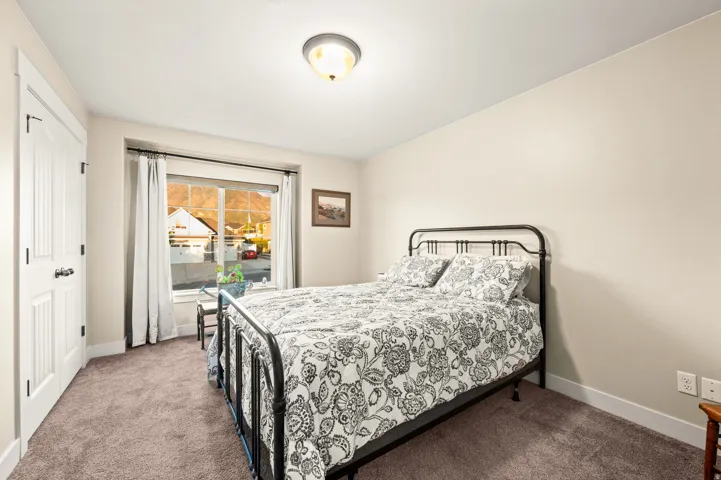 Neutral-toned walls complement the brown carpet flooring and white trim
