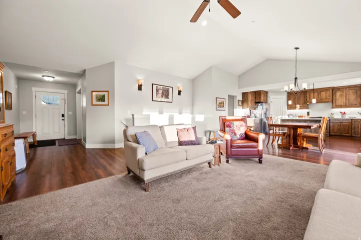 Open-concept living area featuring vaulted ceilings, a ceiling fan, and recessed lighting