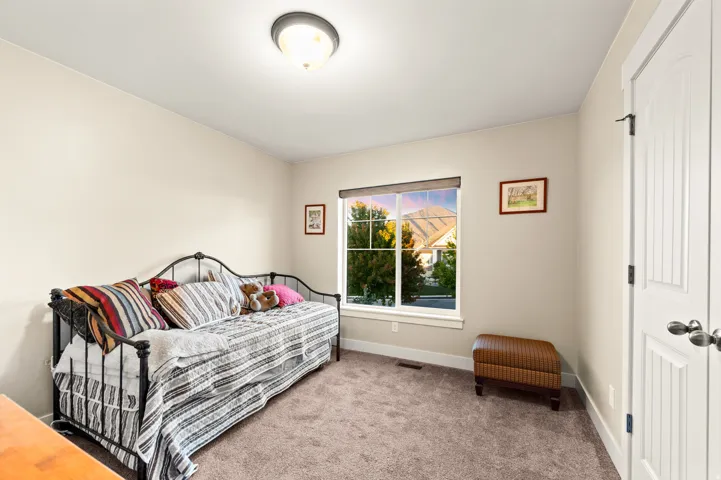 Carpeted room with a double-pane window, white trim, and a flush mount ceiling light
