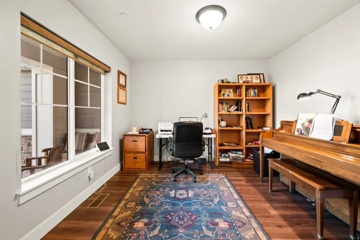 Hardwood-finish flooring throughout, complemented by light gray wall paint and white trim