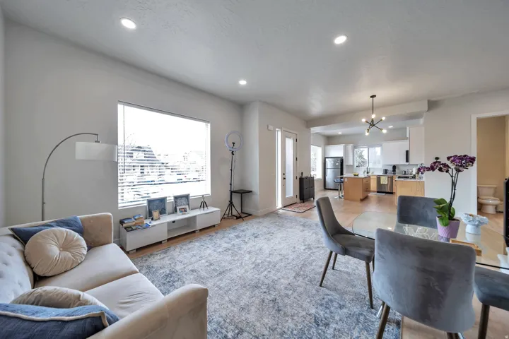 Open-concept living space featuring wood-finish flooring and recessed ceiling lights
