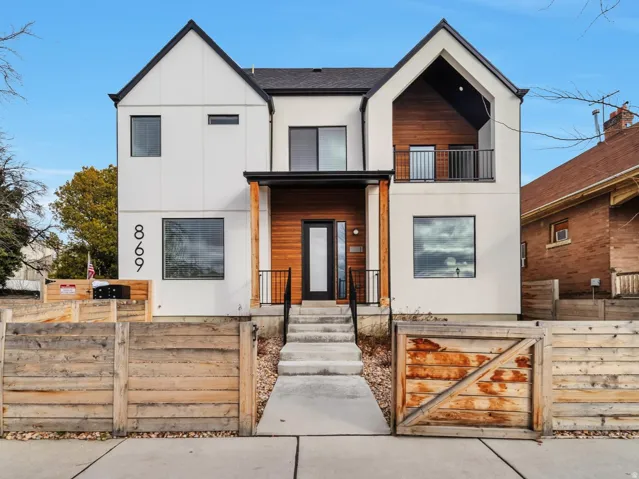 Modern architectural exterior featuring white siding and black trim accents