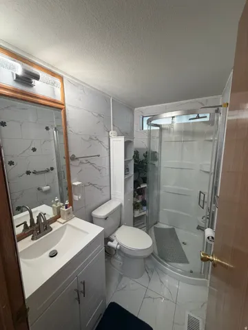 White vanity with brushed nickel fixtures and a rectangular sink