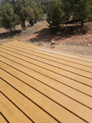 Expansive wood deck featuring horizontal planking and a natural wood finish