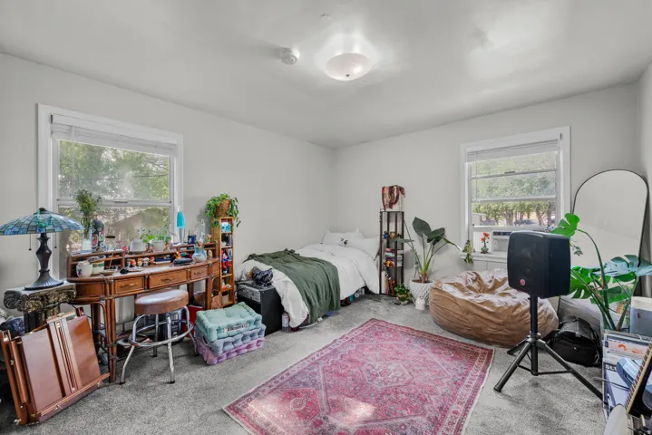 Bedroom featuring light gray walls and gray carpeting