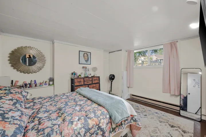 Bedroom with dark wood-finish flooring and a white ceiling