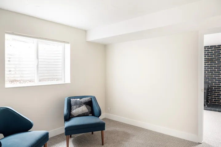 Light-colored walls complement a large egress window