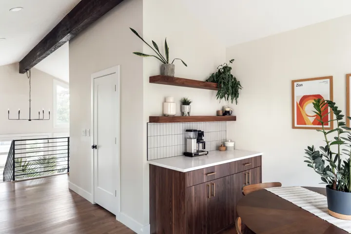Built-in beverage station featuring wood-finish cabinetry, a white countertop, and subway tile backsplash