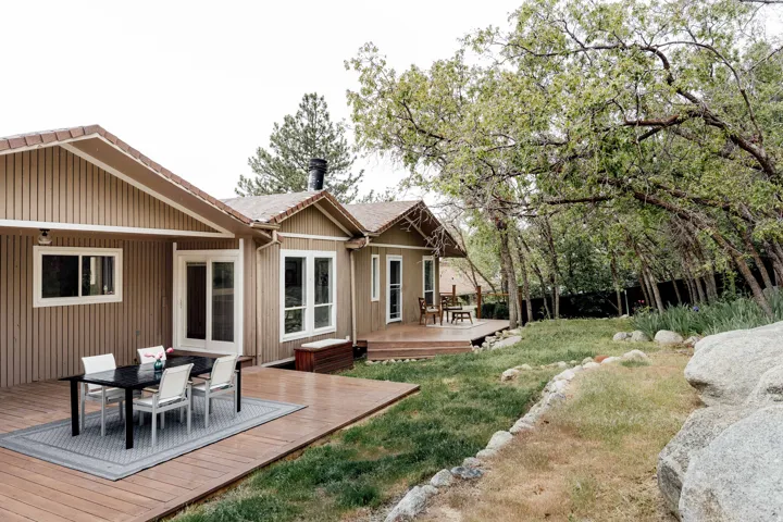 Multi-level exterior wood-finish decking with board and batten siding