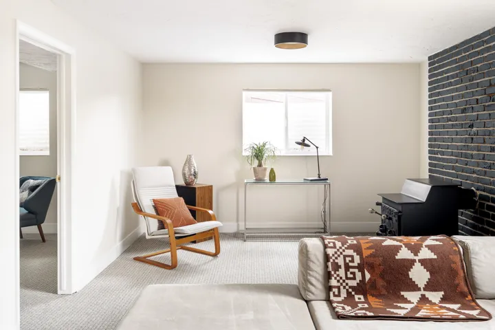 Inviting living area featuring light-toned walls and plush carpeting