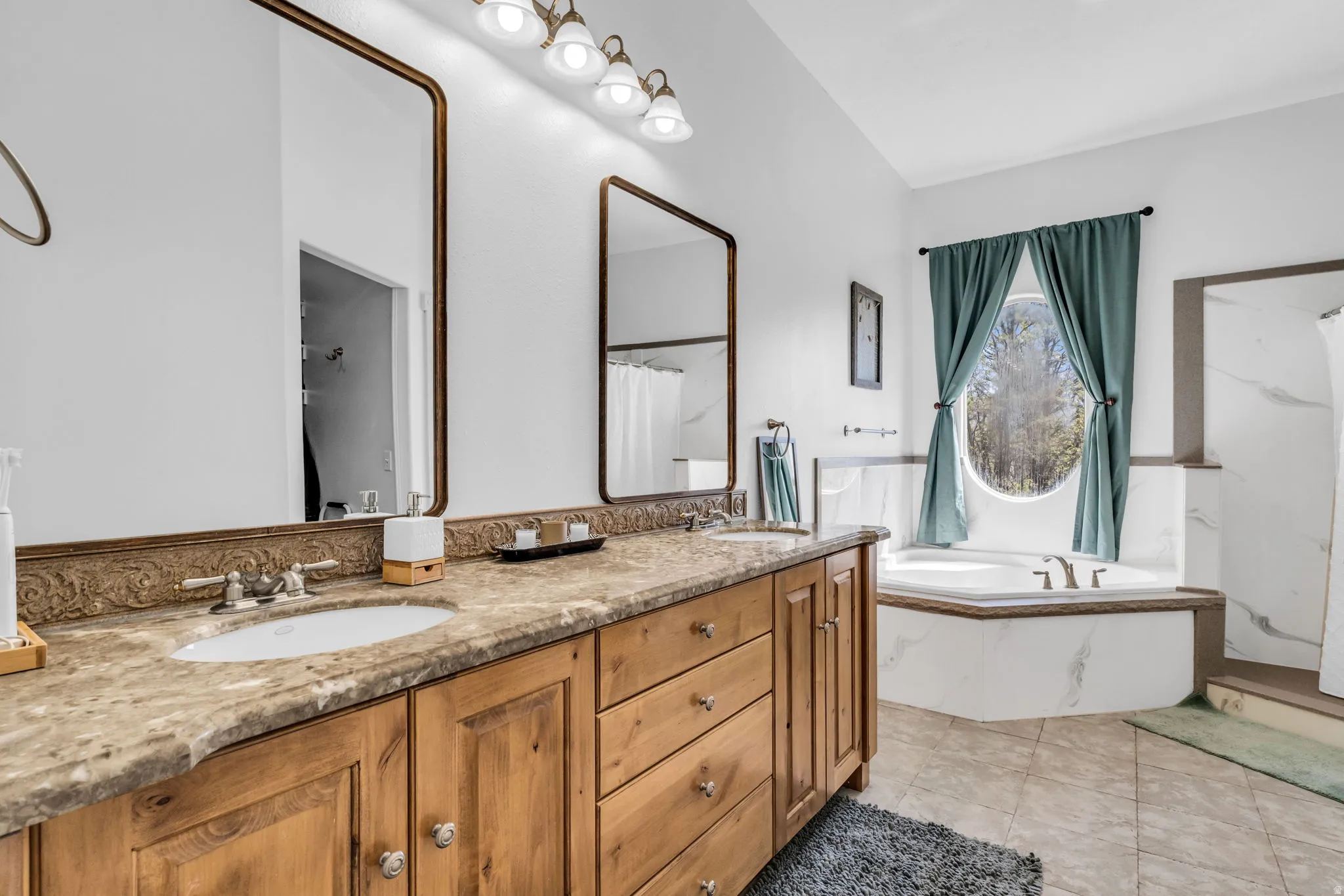 Double vanity with integrated sinks, granite countertop, and custom wood cabinetry