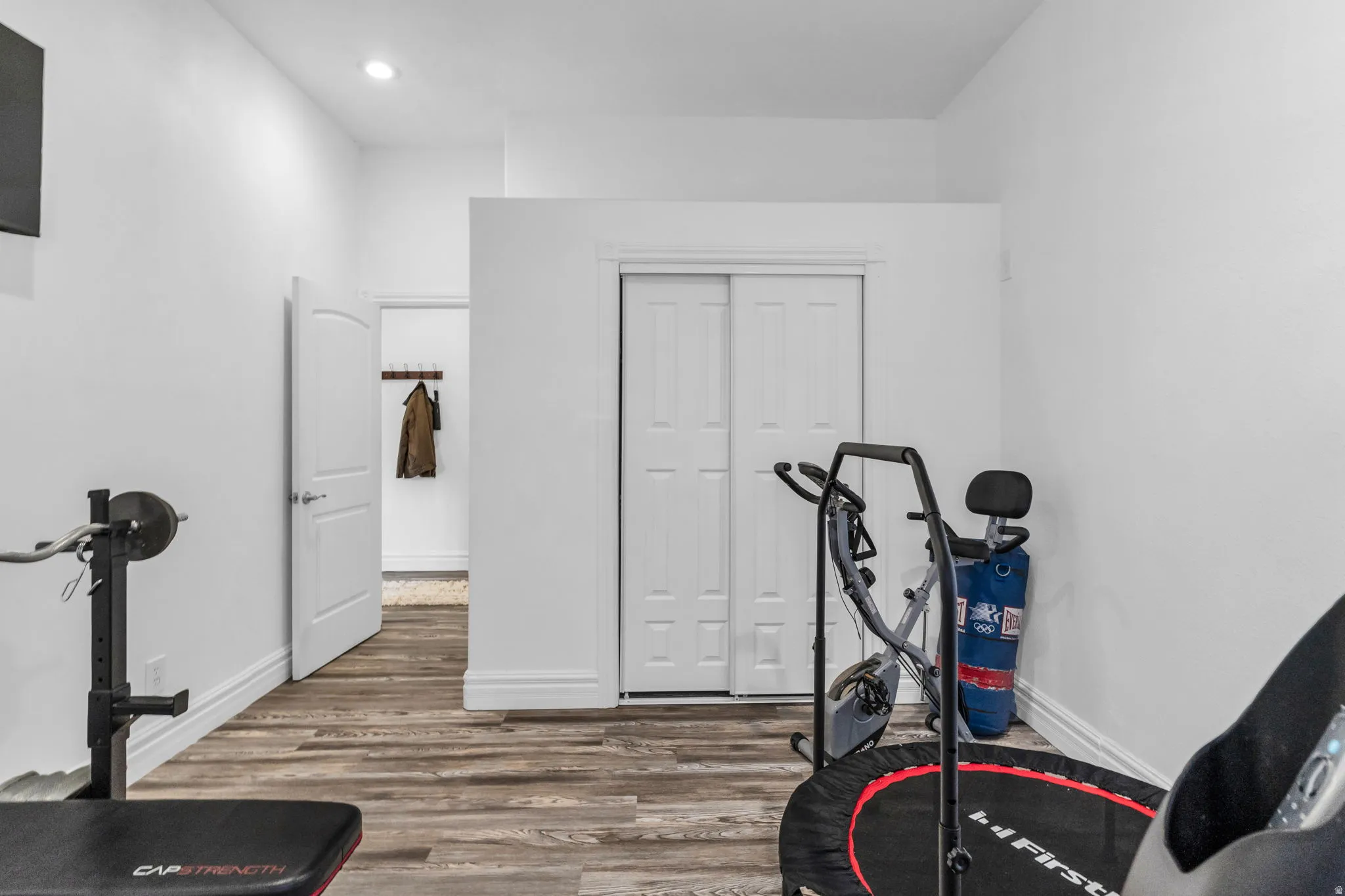 Room featuring wood-finish flooring and bright white walls