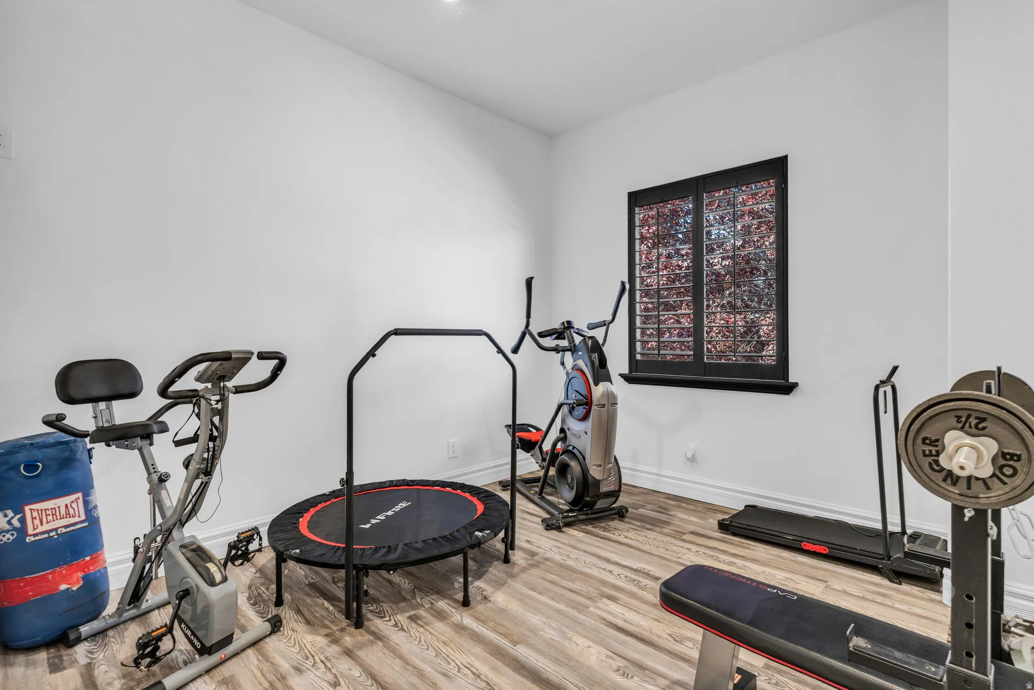 Room featuring light wood-finish flooring, white walls, and recessed lighting