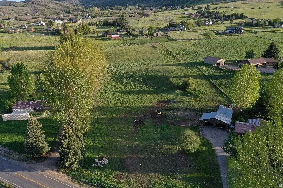 Expansive rural landscape featuring rolling green hills and distant mountains