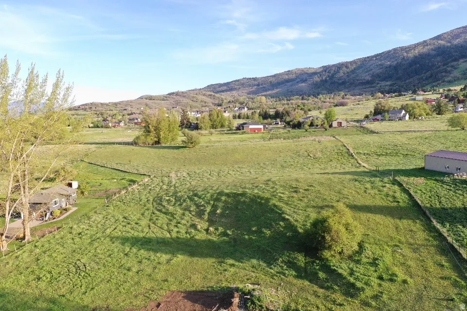 Expansive green acreage with a distant mountain backdrop