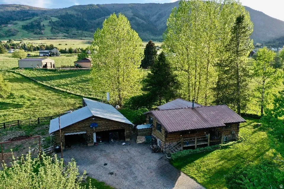 Rustic cabin-style residence featuring a metal roof and an elevated porch