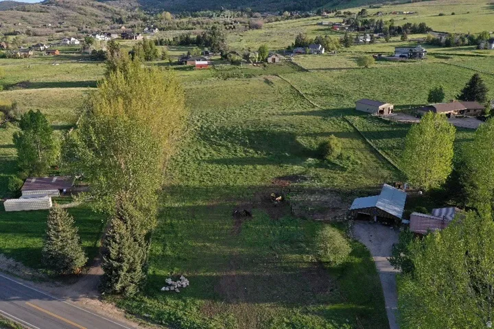 Expansive rural landscape featuring rolling green hills and distant mountains