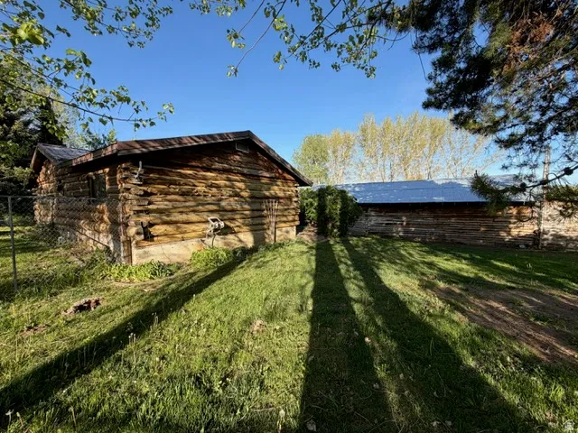 Two rustic log structures with metal roofing
