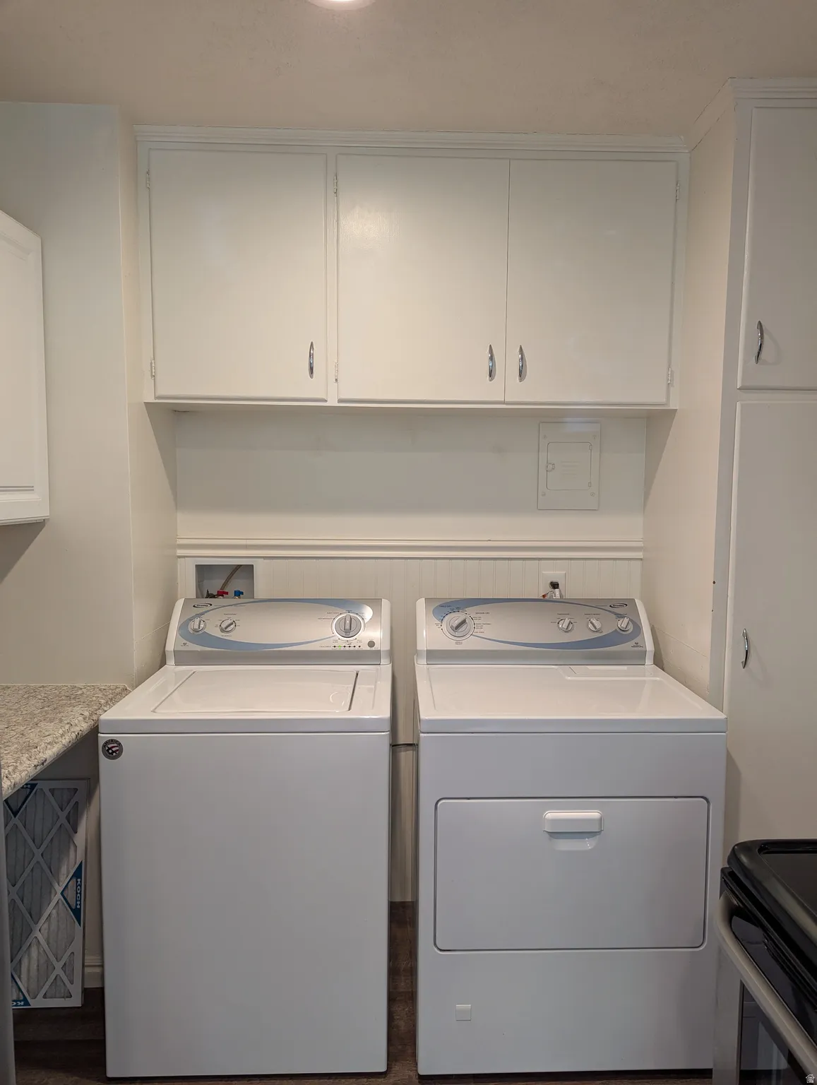 Laundry area featuring white upper cabinetry